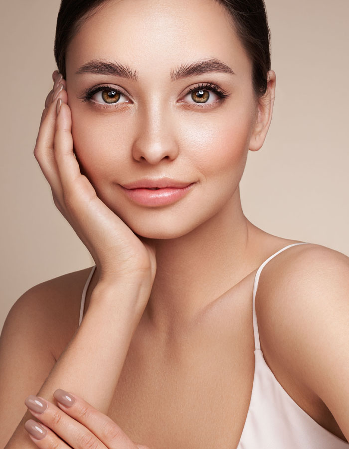 Young woman touching her face