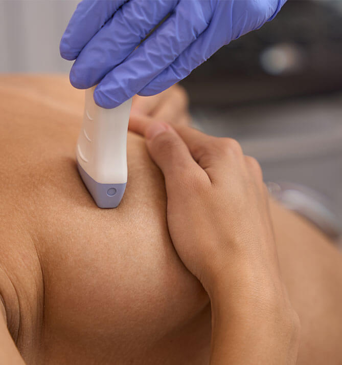 Woman having a sonogram on her breast done